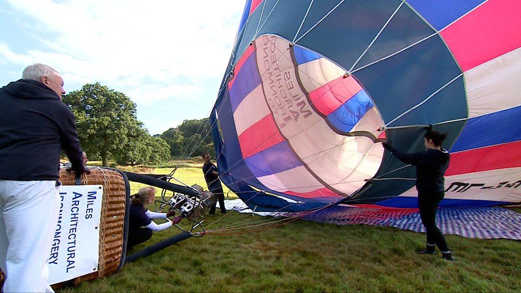 The Miles family holding a hot air balloon