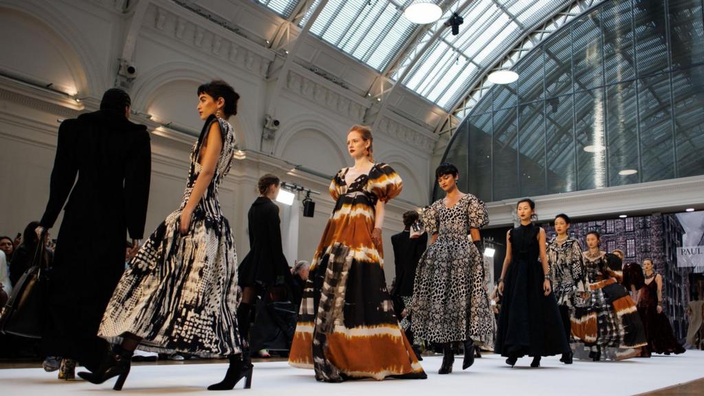 Models present creations by Irish designer Paul Costelloe during the London Fashion Week