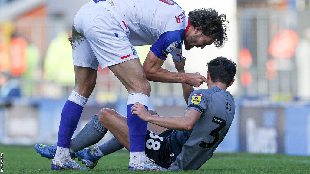 Sam Gallagher (left) of Blackburn Rovers and Perry Ng of Cardiff City square up