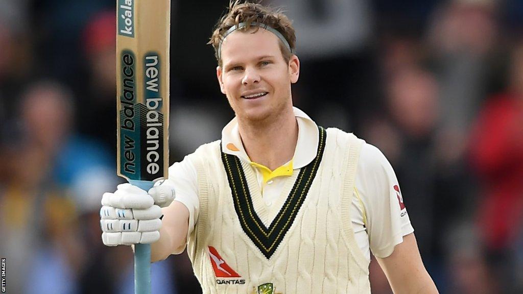 Steve Smith raises his bat in celebration