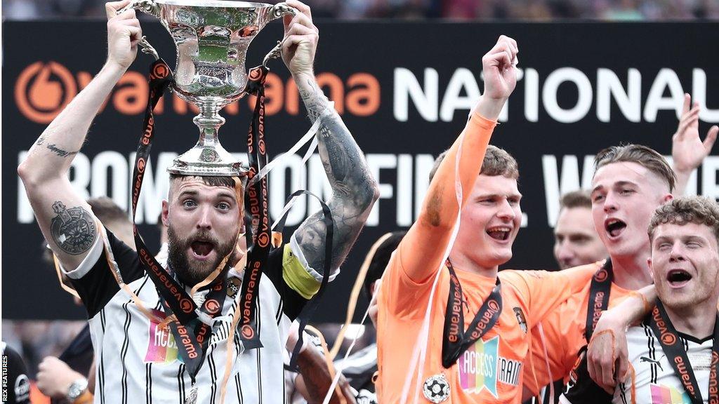 Kyle Cameron celebrates with the trophy after Notts County secure promotion at Wembley