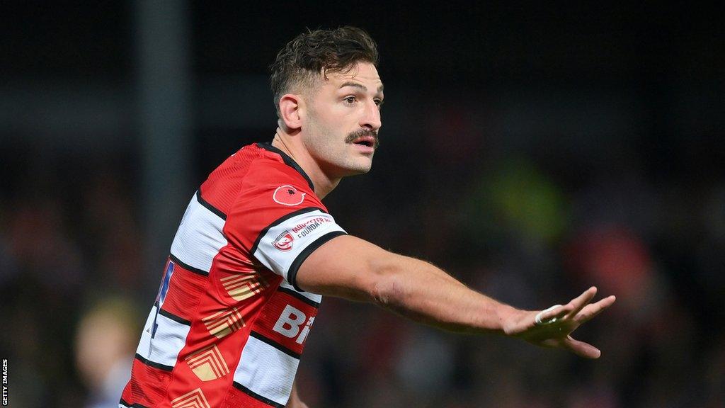 Jonny May holds his arm out during Gloucester's match with Bath