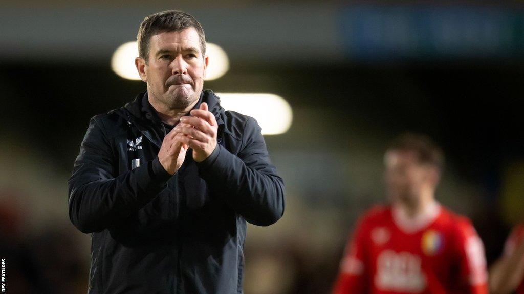 Mansfield boss Nigel Clough claps his hands after a game