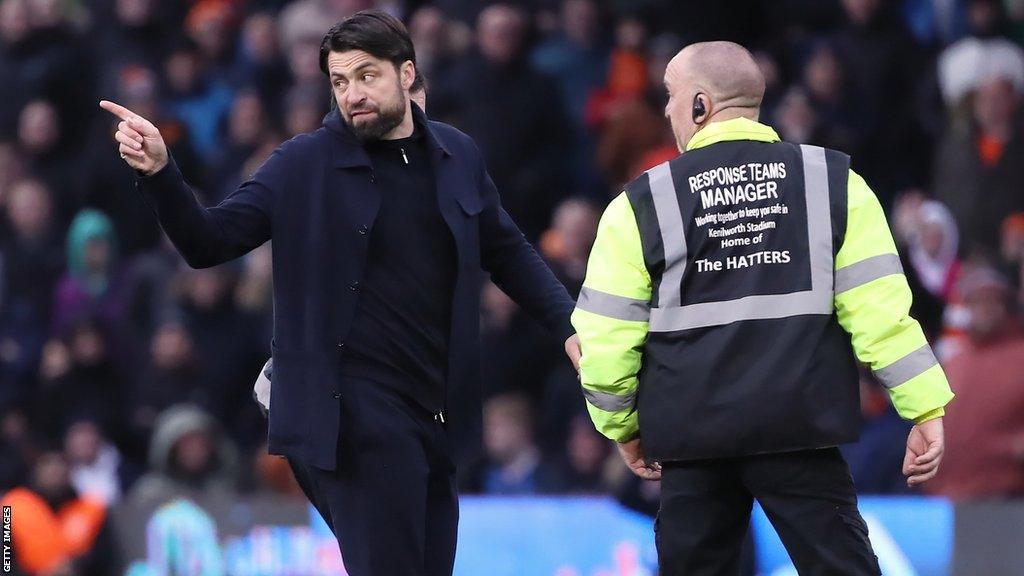 Russell Martin remonstrates with referee Dean Whitestone as he is led off the Kenilworth Road pitch