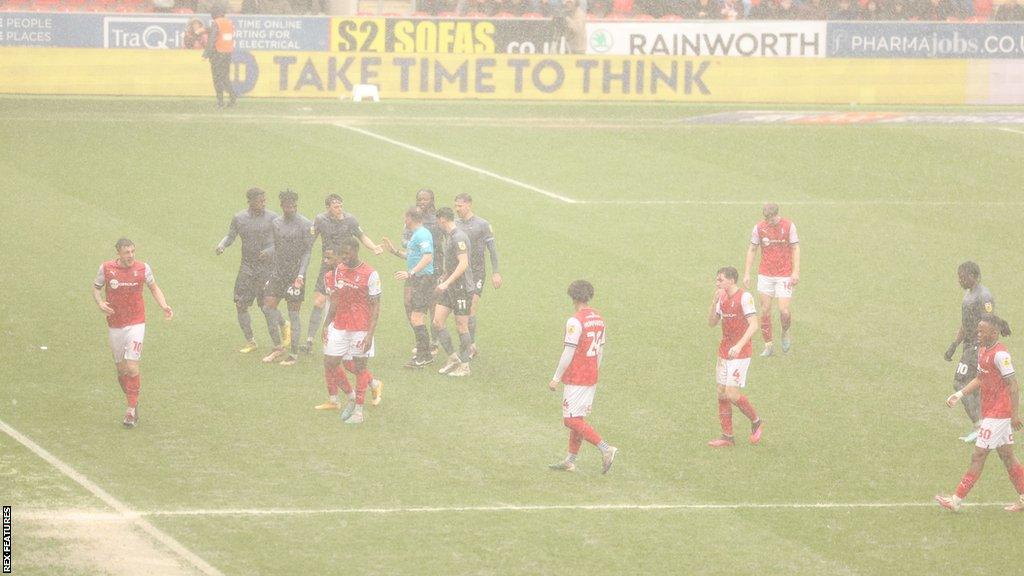 Rain forces the players off the pitch