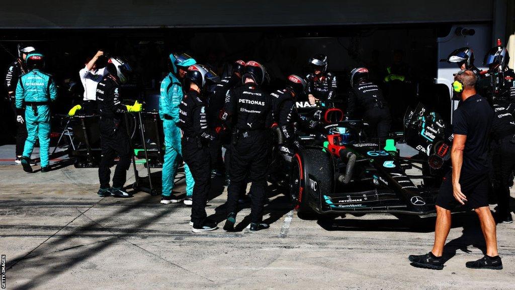 Mercedes' George Russell drives into the pit garage to retire from the Sao Paulo Grand Prix