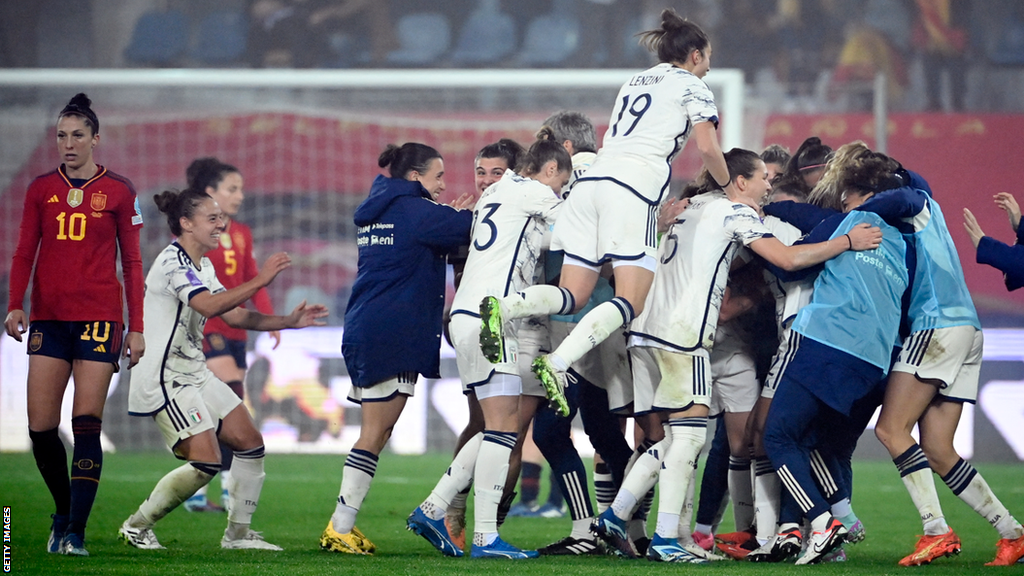 Italy's players celebrate scoring against Spain