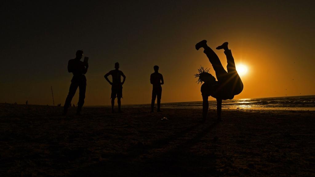 Young men perform acrobatics on the beach in Serekunda outside Banjul in The Gambia - 23 January 2017