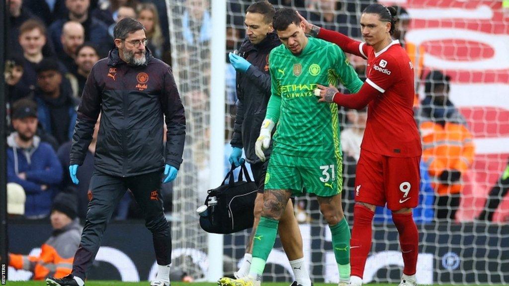 Ederson is consoled by Darwin Nunez as he is substituted following an injury