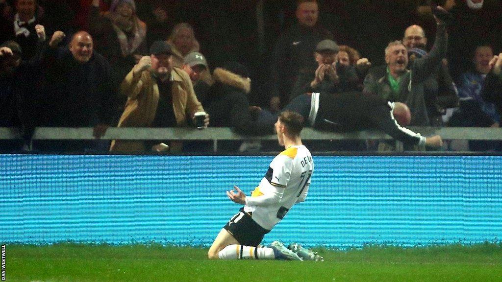 Alfie Devine celebrates his matchwinner in front of the Vale fans