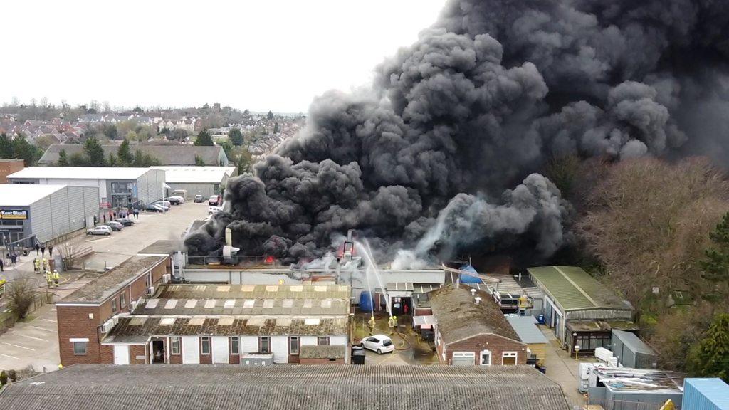 Smoke pouring out of a two-storey on an industrial estate in Saffron Walden as firefighters spray water on to the flames.