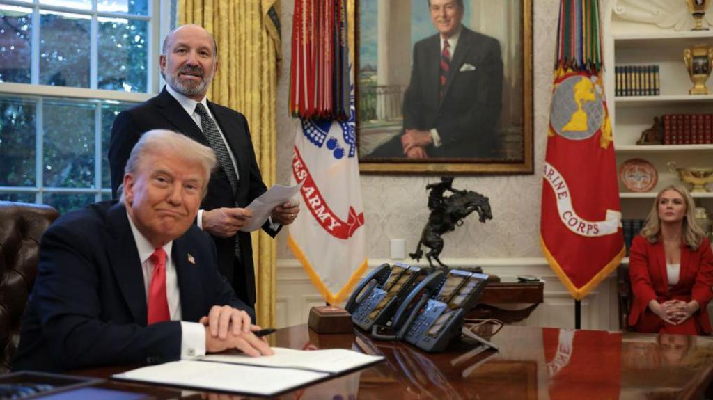 U.S. Commerce Secretary Howard Lutnick (2nd-L) speaks as President Donald Trump prepares to sign an executive order in the Oval Office at the White House on February 25, 2025 in Washington, DC. 