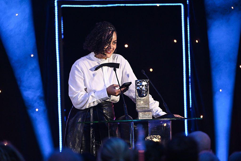 A woman picking up an award