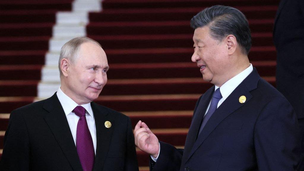 This pool photograph distributed by Russian state owned agency Sputnik shows Russia's President Vladimir Putin and Chinese President Xi Jinping interacting during a welcoming ceremony at the Third Belt and Road Forum in Beijing on October 17, 2023.