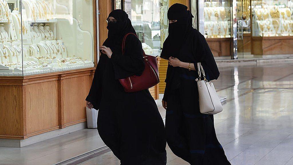 Saudi women walk past a jewellery shop at Tiba market in Riyadh.