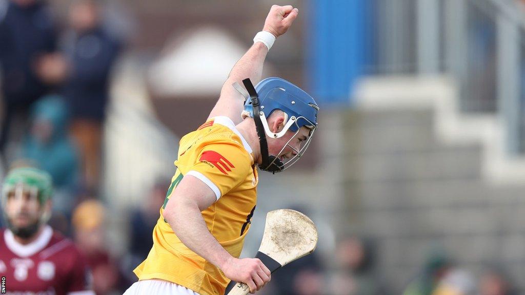 Joseph McLaughlin celebrates after scoring Antrim's goal in the first half