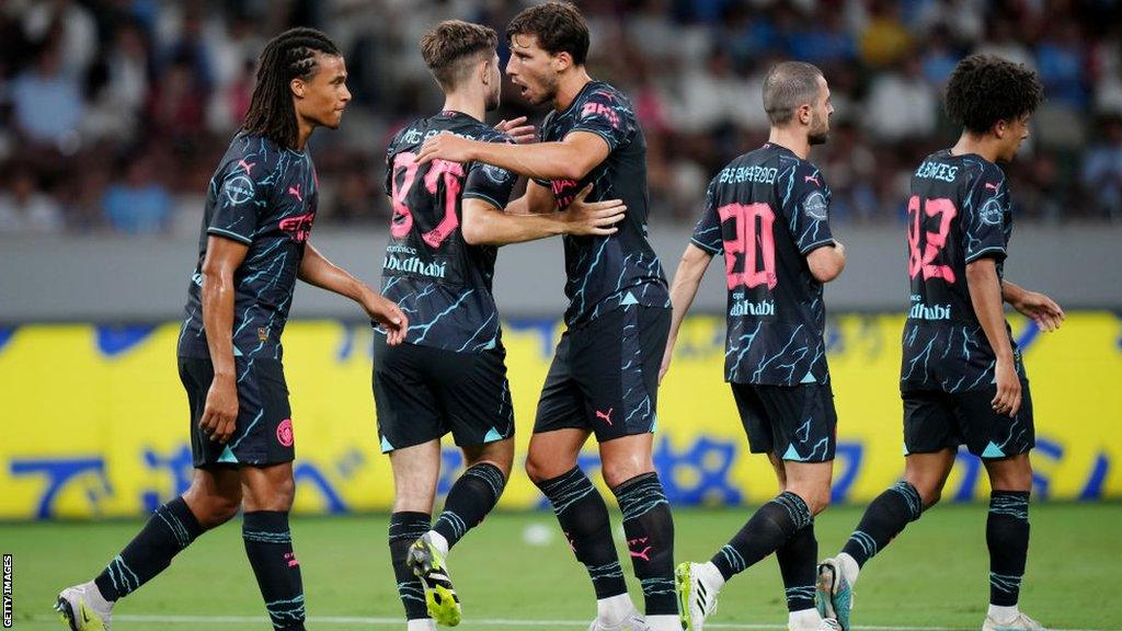 James McAtee of Manchester City celebrates with team-mates after scoring their side's first goal