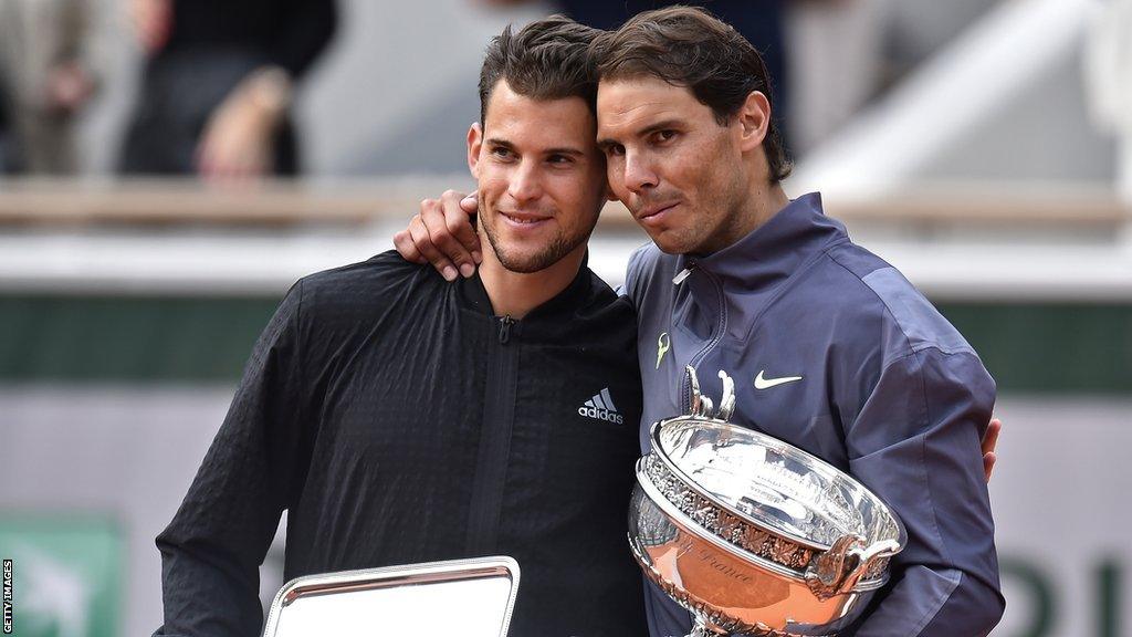 Dominic Thiem is hugged by Rafael Nadal after their 2019 French Open final