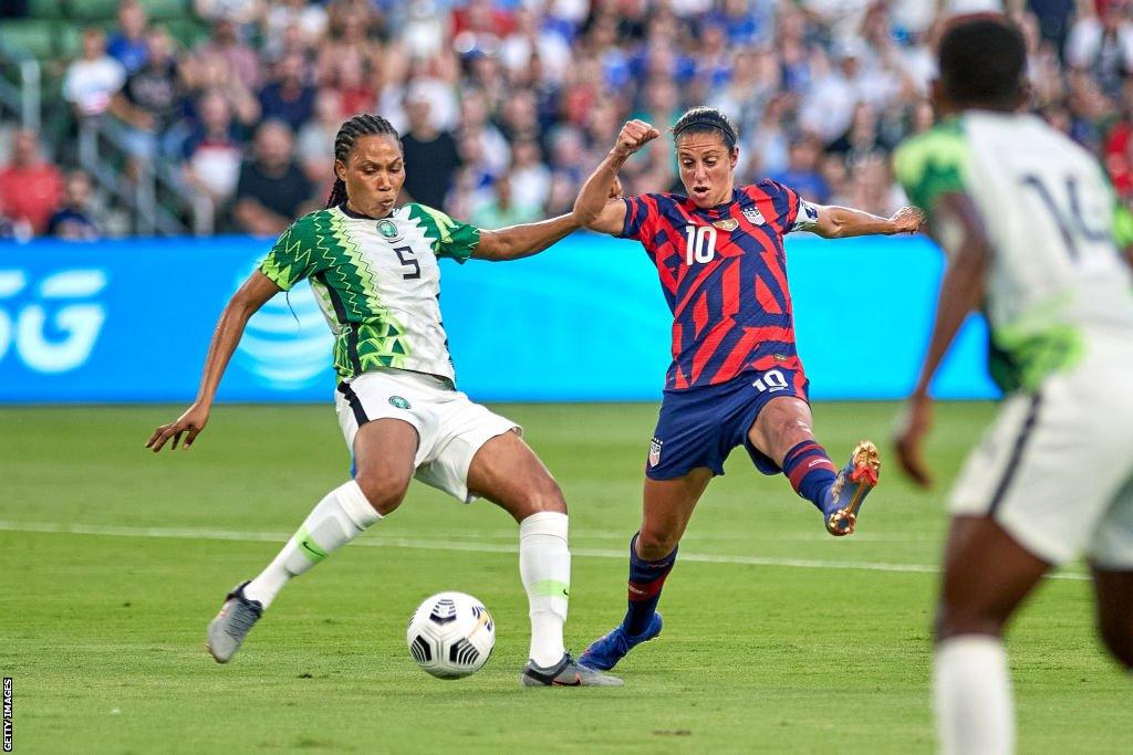 Onome Ebi battles with United States forward Carli Lloyd in a Summer Series friendly