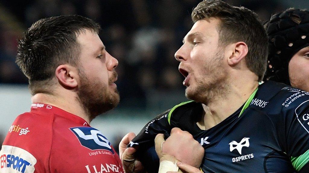 Scarlets prop Rob Evans and Ospreys fly-half Dan Biggar tussle