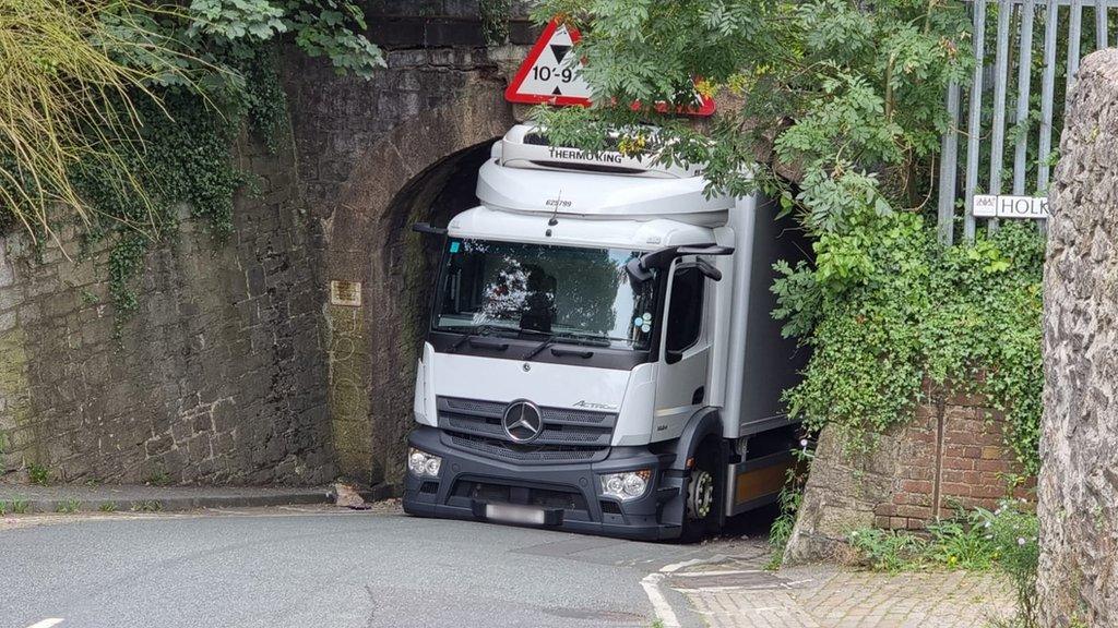 Lorry stuck under bridge