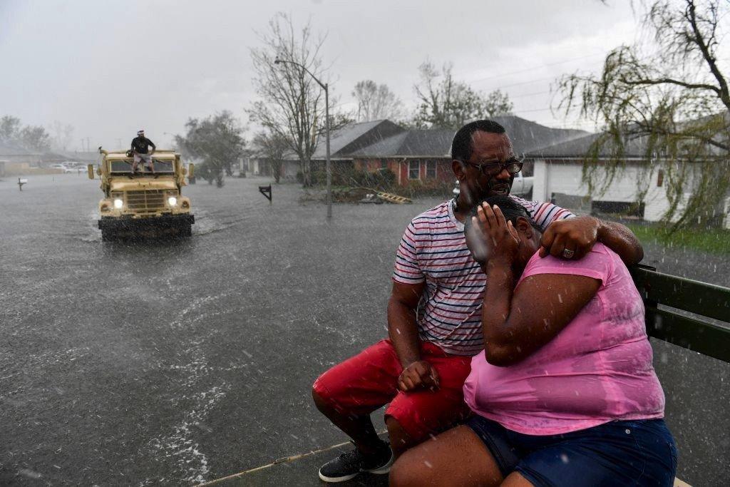 Couple huddling together in hurricane