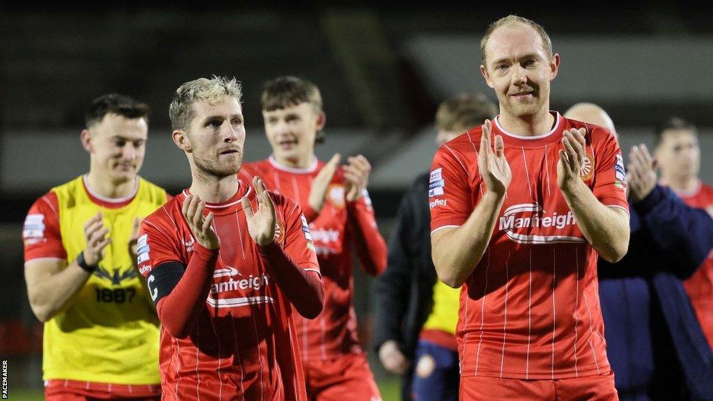 Portadown players applaud their supporters after defeating Crusaders at Shamrock Park