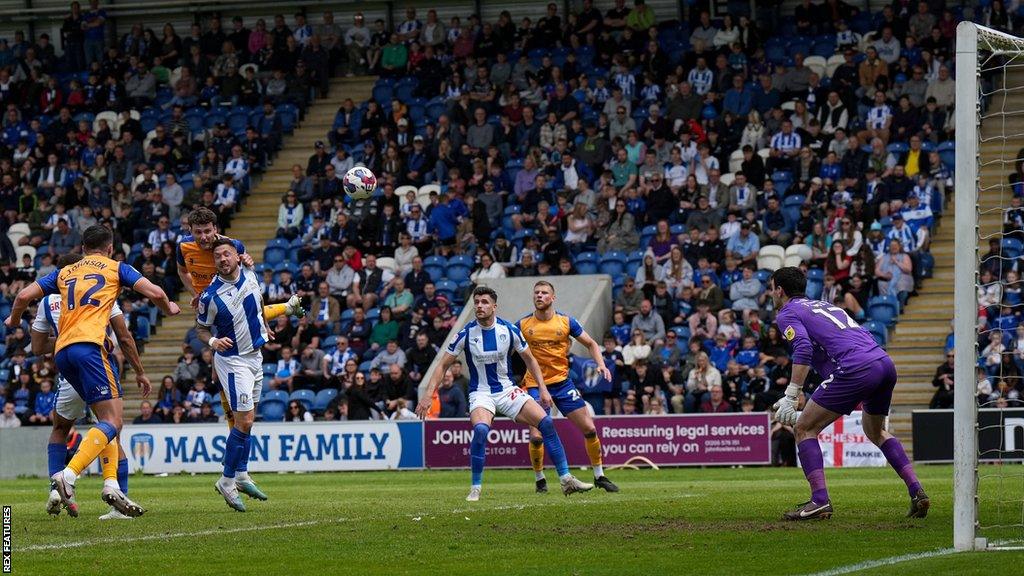 Mansfield Town's Riley Harbottle heads them in front against Colchester United