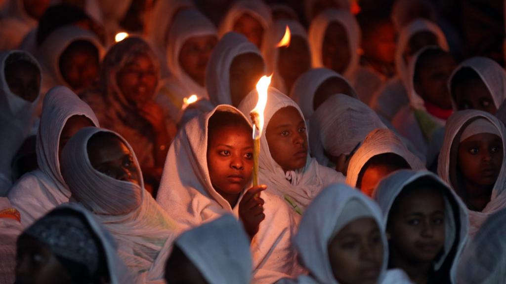 Woman holding a candle during an Ethiopian celebration