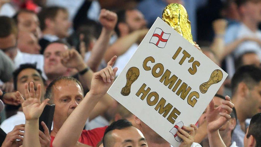 Fans-holding-a-sign-saying-Its-coming-home.