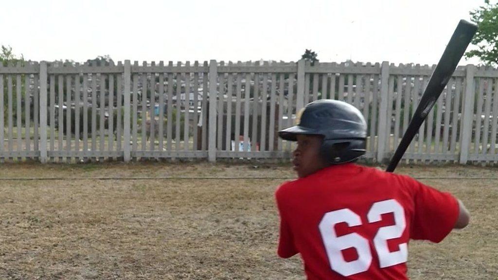 Player prepares to hit baseball