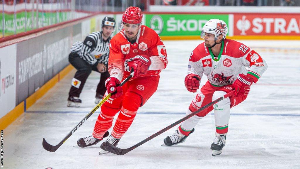 Damien Riat of Lausanne HC battles with Justin Crandall of Cardiff Devils in their CHL group game in 2021