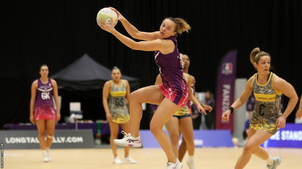 Hannah Joseph jumps with the ball v Rhinos