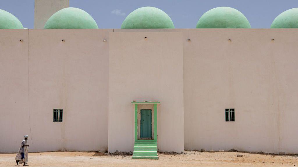 A man arrives at the Grand Mosque for Friday prayers in Nouakchott on June 28, 2024. 