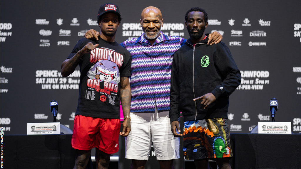 Mike Tyson stands in between Errol Spence and Terence Crawford