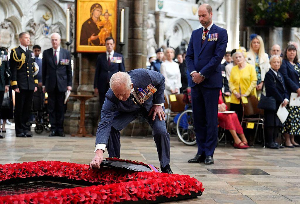 King Charles laying a wreath.