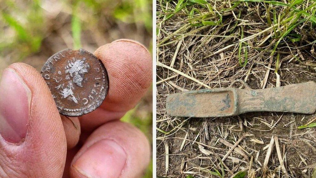 A silver Roman coin and a Bronze Age axe