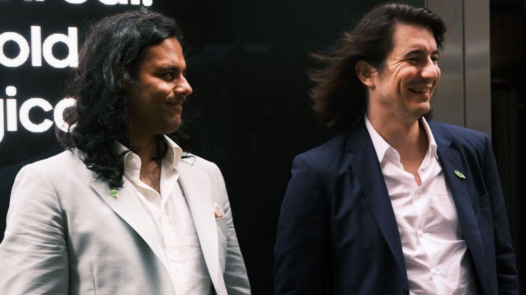 Baiju Bhatt (left) and Vlad Tenev, founders of the online brokerage Robinhood, walk along Wall Street after going public with an IPO earlier in the day on July 29