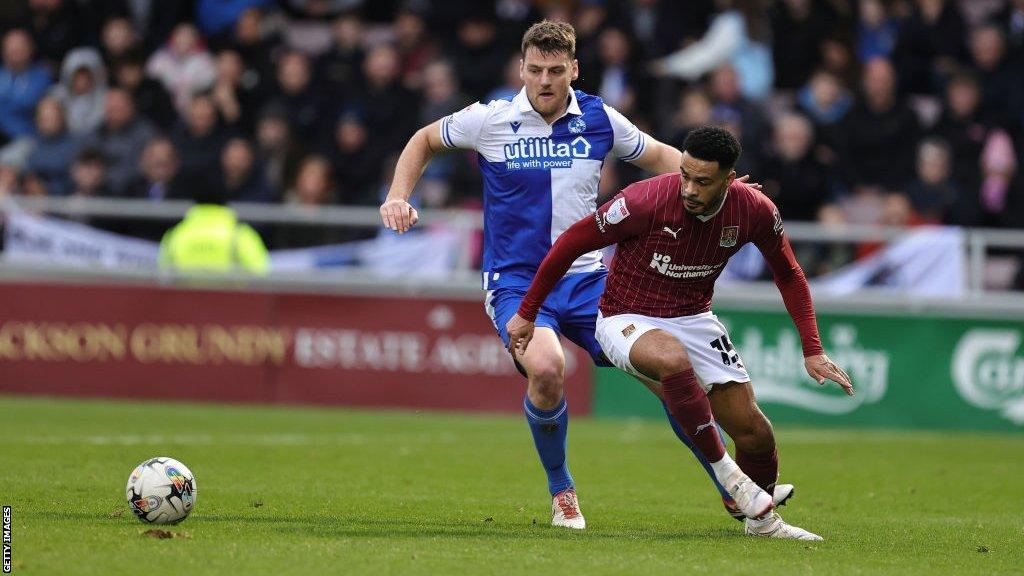 Chris Martin challenges a defender for the ball