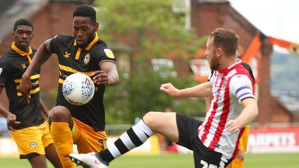 Jamille Matt of Newport County takes on Jake Taylor of Exeter City