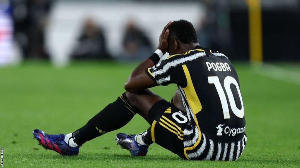 Paul Pogba sits on the pitch