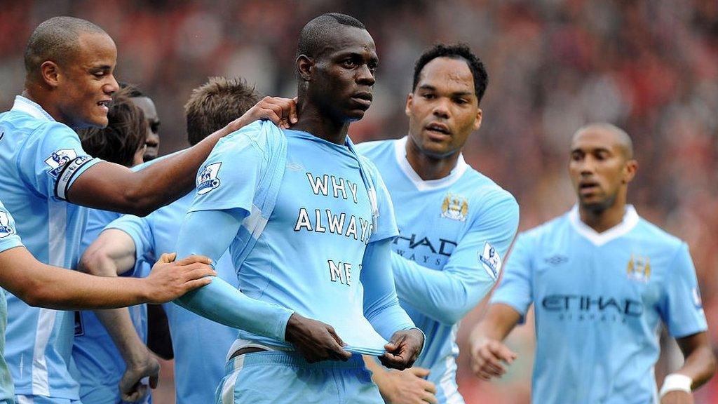 Mario Balotelli celebrates for Manchester City after scoring against Manchester United