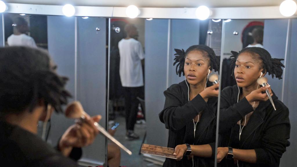 A model doing her makeup backstage at a Soweto Fashion Week event in South Africa - May 2023