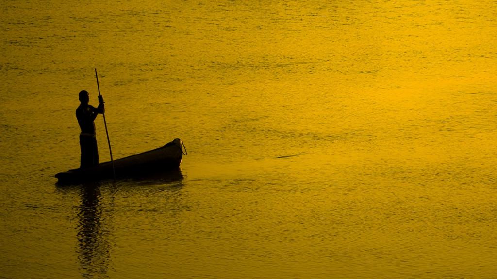 Man in boat silhouetted