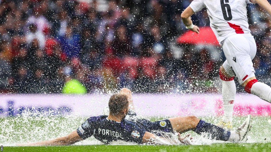 Slide tackle in the rain at Hampden