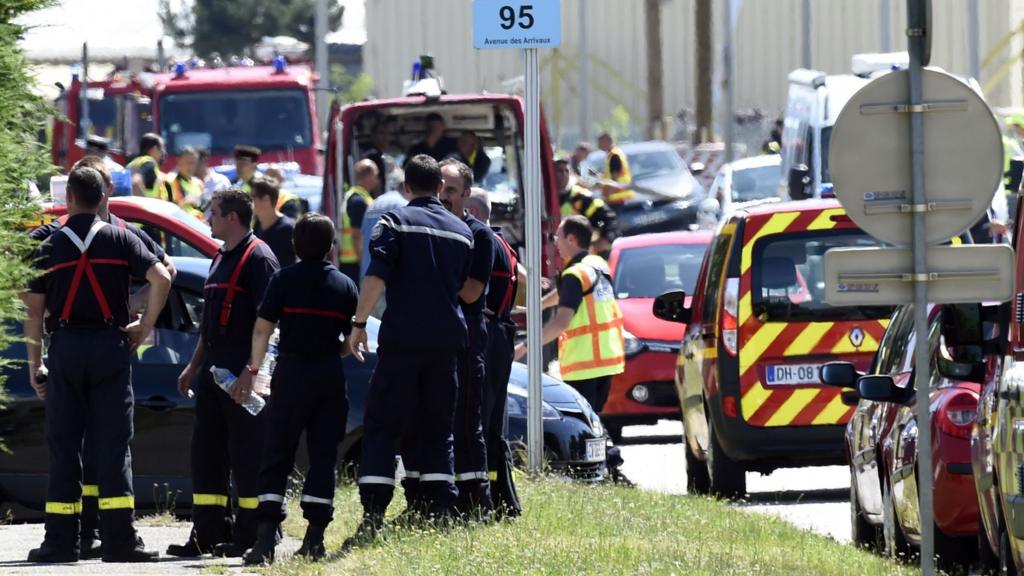 French police and firefighters gather at the entrance of the Air Products company in Saint-Quentin-Fallavier, near Lyon