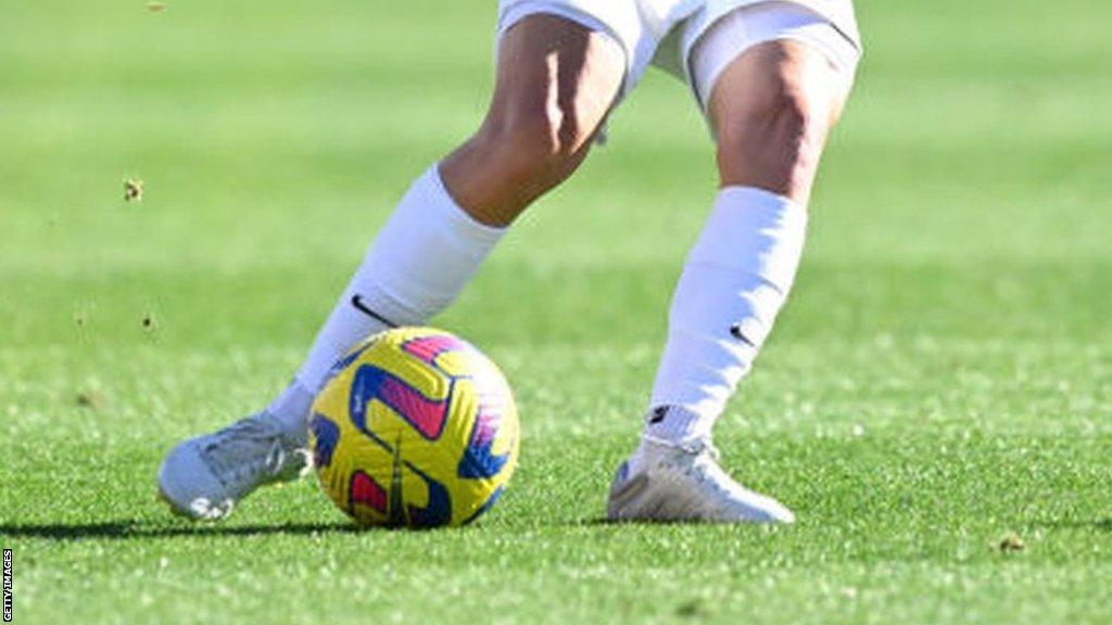 Woman kicking a football