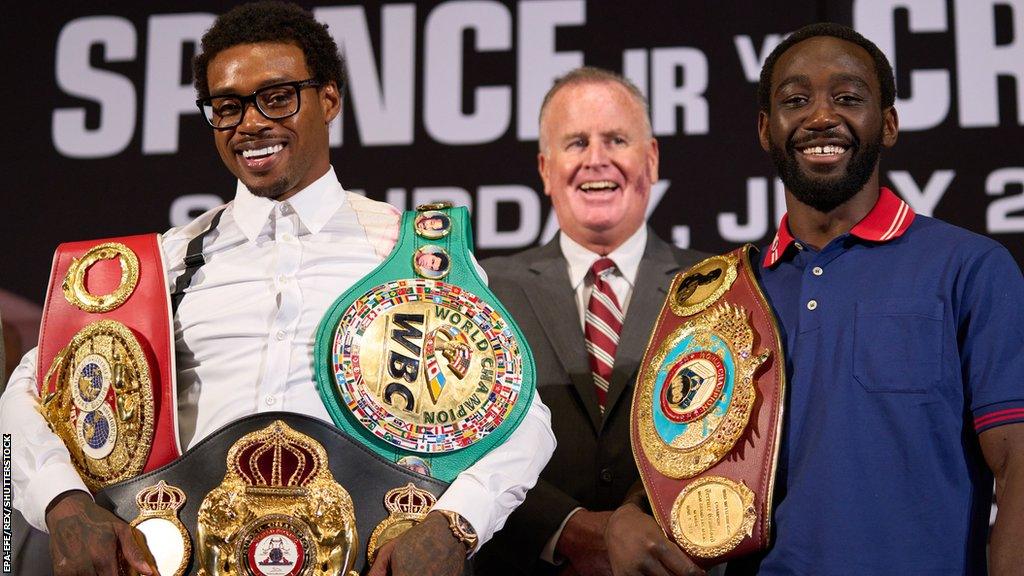 Errol Spence Jr and Terence Crawford pose with their world titles