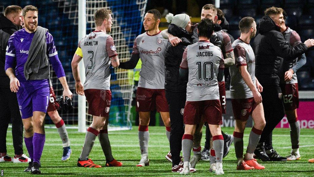 Arbroath team-mates surround Ali Adams at full-time