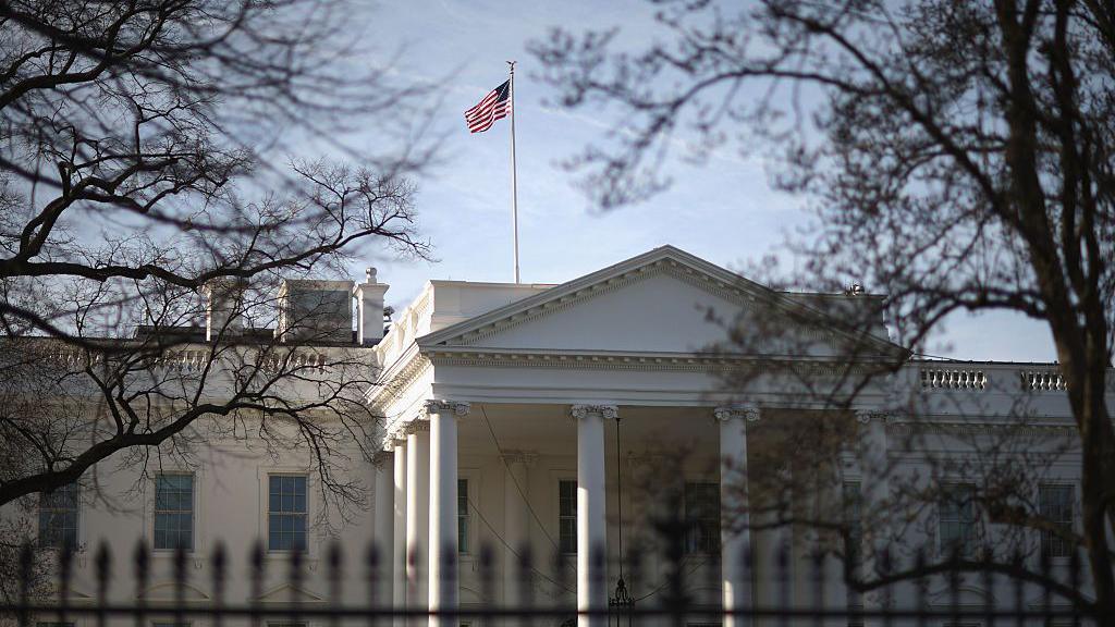 Morning sunlight strikes the flag flying above the White House March 18, 2015 in Washington, DC.